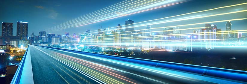 Skyline at night with movement on highway