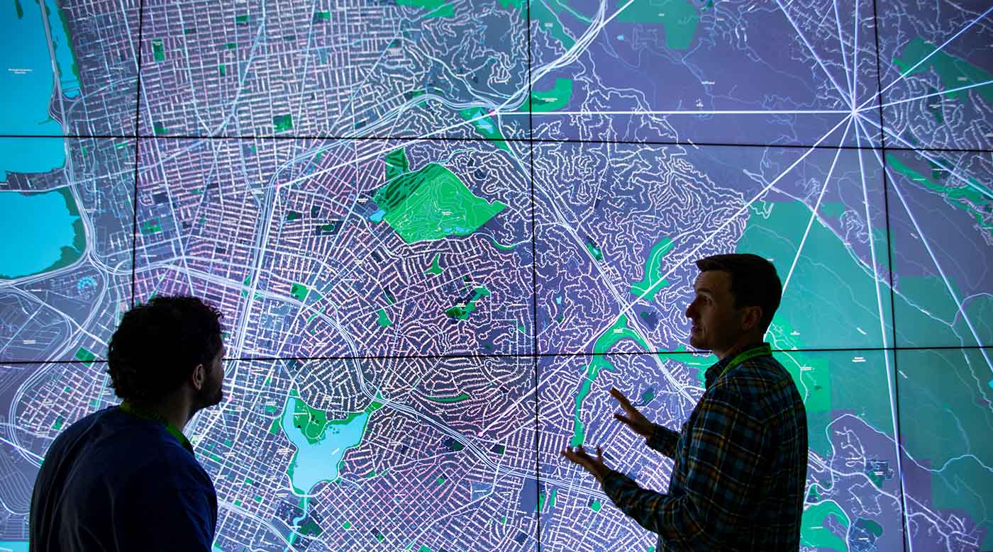 Researchers examine a projection of a grid in NREL's 2-D Visualization Laboratory