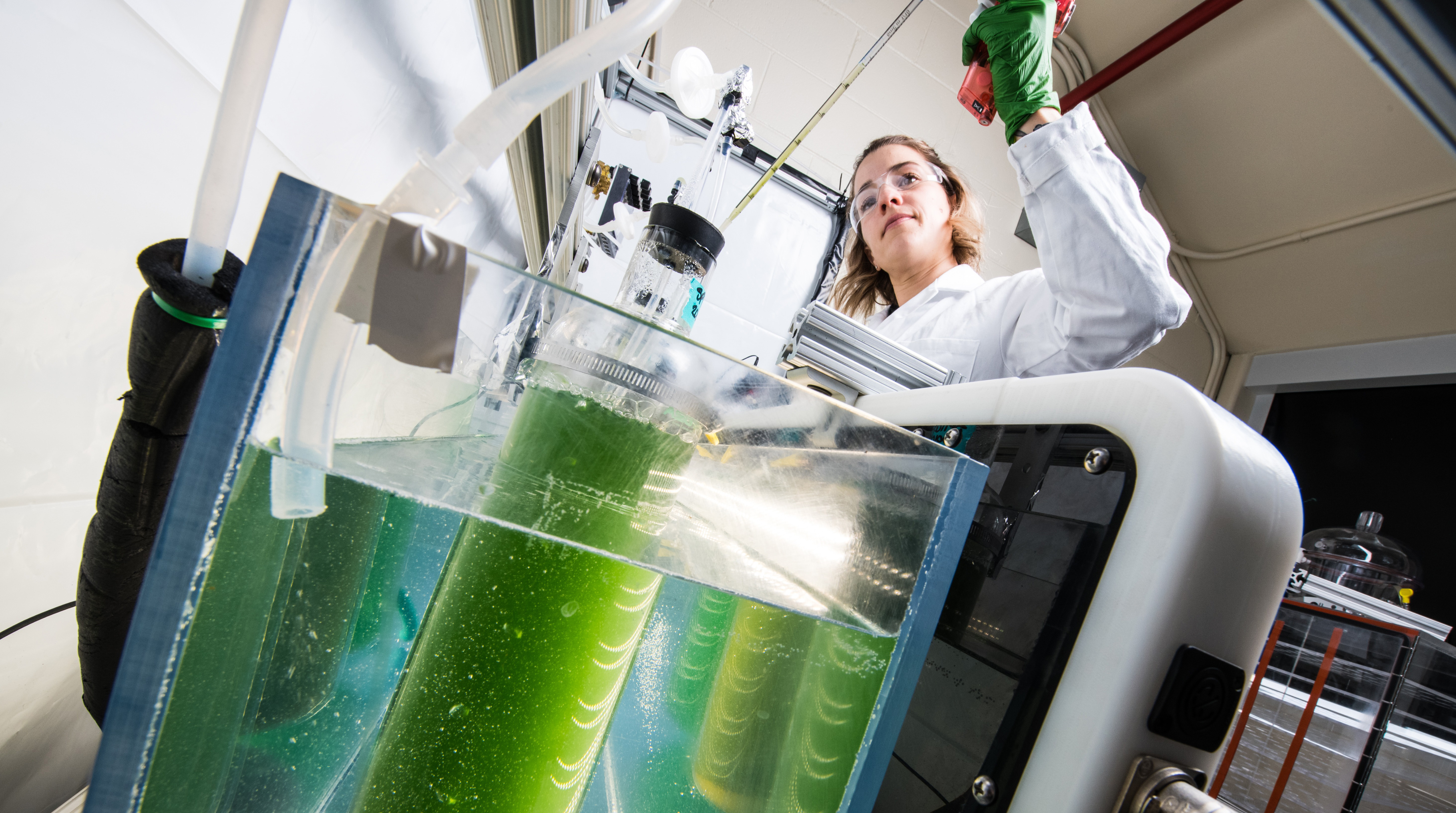 one researcher working on equipment in a lab