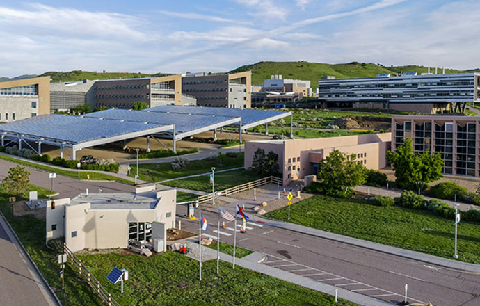 Aerial view of scientific laboratories with green mountains in the background.