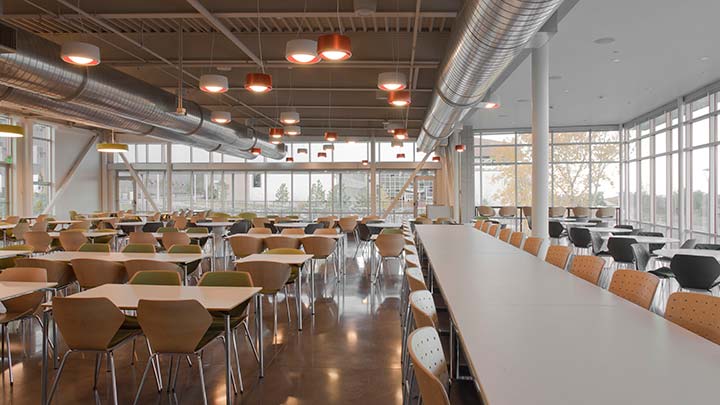 Empty tables and chairs in a cafeteria.