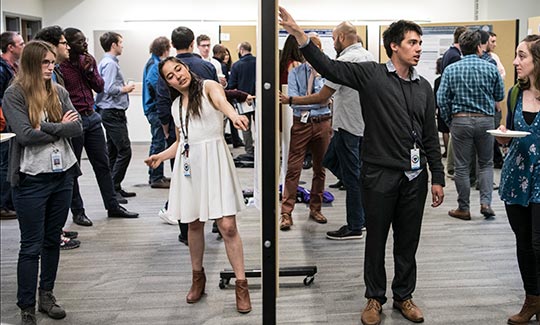 Interns discuss their science posters at the Intern Poster Session.