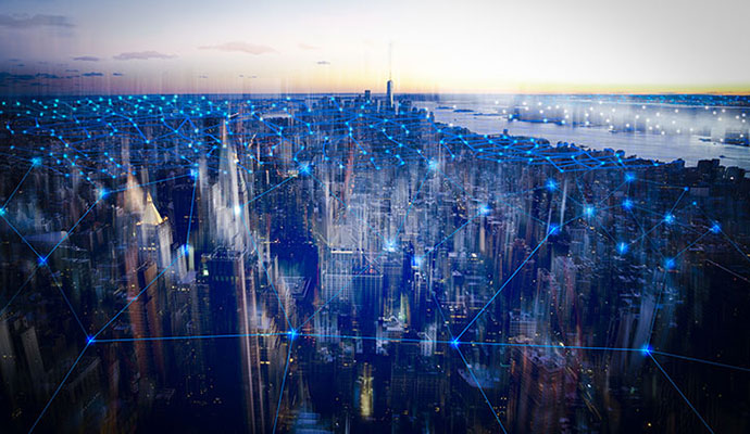 Aerial view of city at dusk connected by bright lines