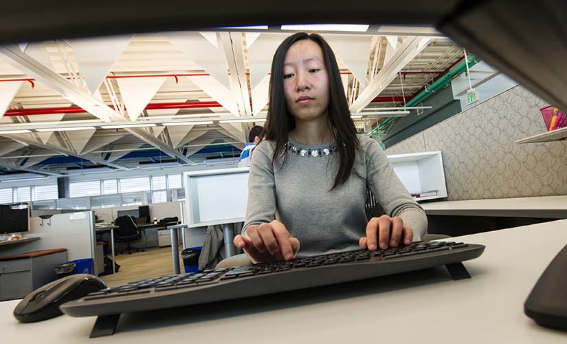 An NREL Post-Doctorate researcher works on grid analysis.