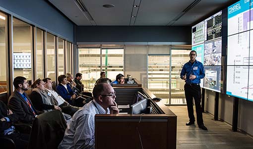 Photo of an NREL researcher presenting in the Energy Systems Integration Facility Control Room.