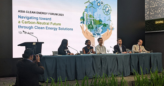 People on stage giving panel discussion.