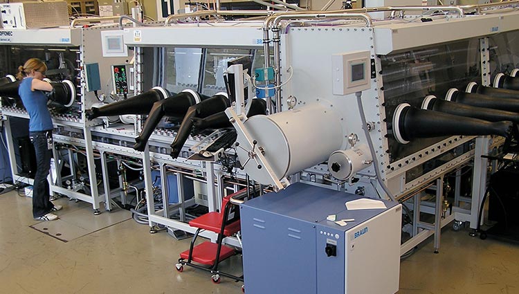 Photo of a researcher operating a large piece of lab equipment