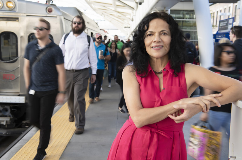 Woman standing on train platform.