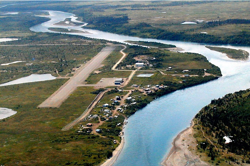 An aerial view of a village on a river