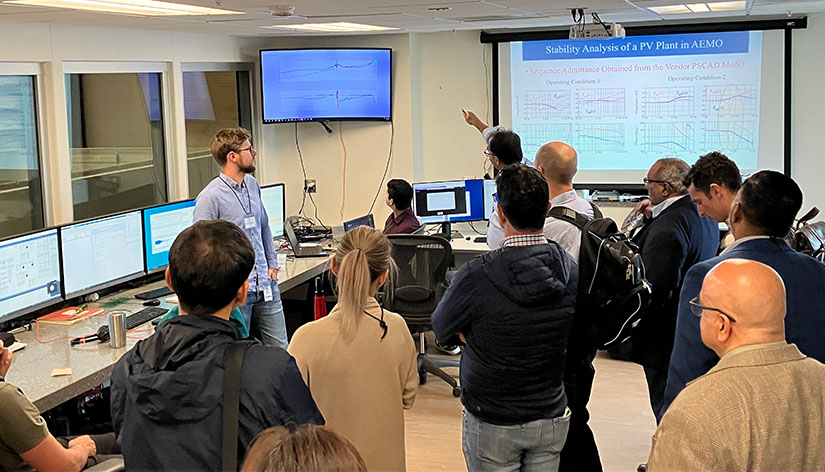 A group of people looking at a presentation screen.