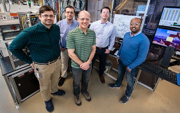 A group of five men in a lab