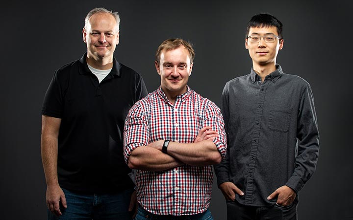 Three scientists pose for a photo