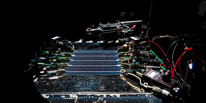 Five-busbar industrial c-Si wafer cell undergoing Kelvin probe measurement of short circuit current.