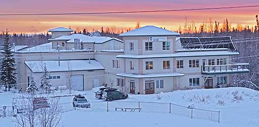 The Cold Climate Housing Research Center building in the snow at sunrise