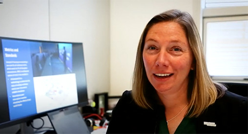 Eliza Hotchkiss sits in front of computer screen in office