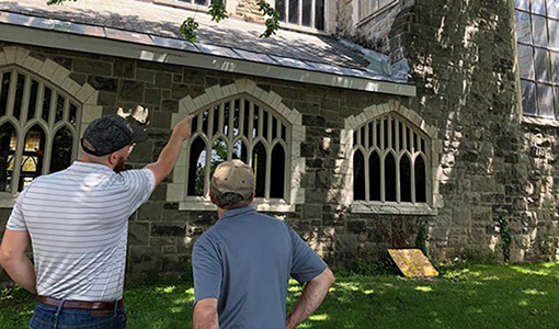 Two people looking at historic library being retrofitted to be more energy efficient.