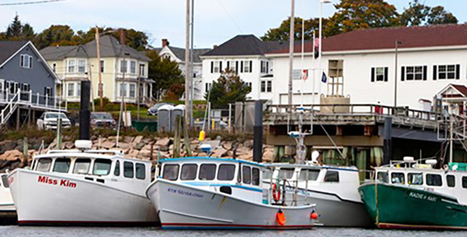 Boats on water in front of buildings.