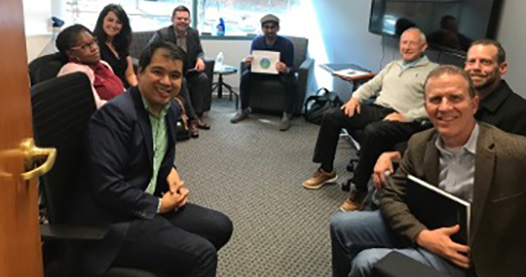 Group of people sit inside conference room