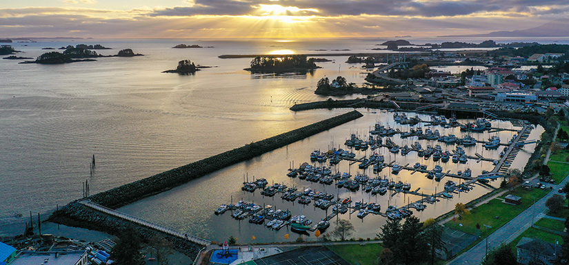 Sunbeams and clouds over a harbor with boats