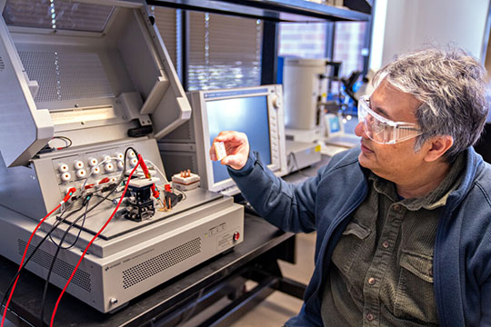 Faisal Khan holds a small wireless controller for a power module.