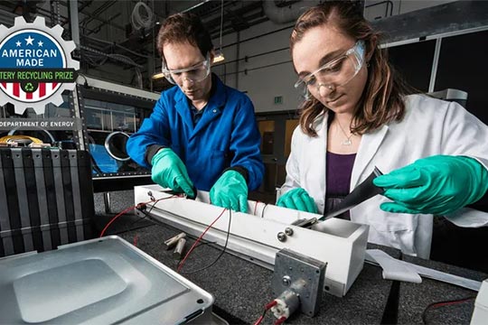 Two scientists perform an experiment with electronic devices.