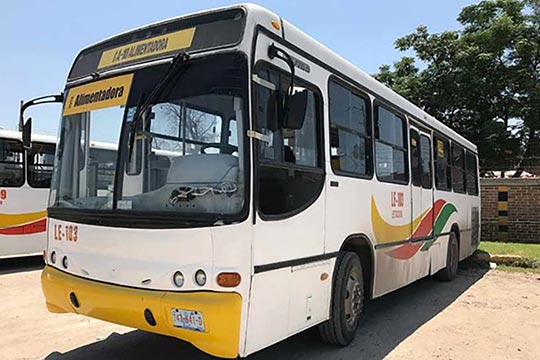 A yellow and white transit bus