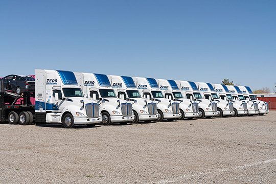 A fleet of zero-emission semitrucks parked next to each other.