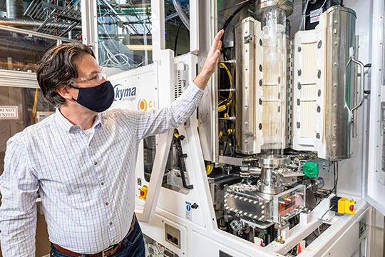 Researcher showing an electric reactor.