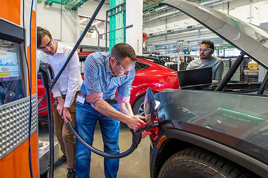 A group of people working on a car.