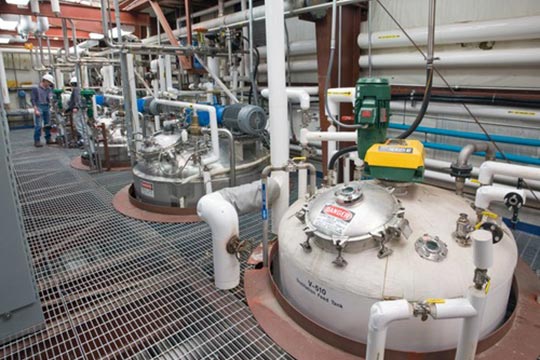 Row of fermenter tanks in a pilot plant facility.