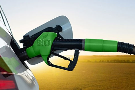 A car fueling up with biofuels in a rural setting.