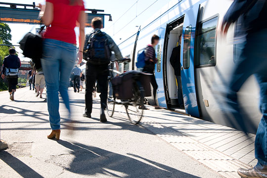 Photo of people walking next to a train.