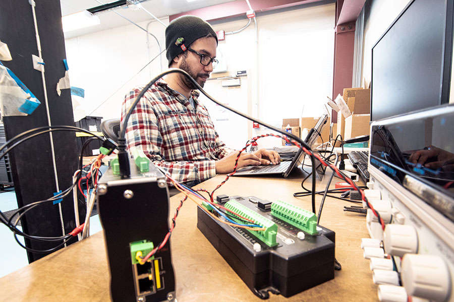 Person performs data tests on computer inside lab.