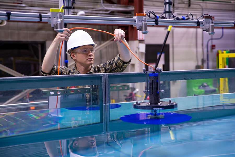 Person testing motion platform in wave tank.