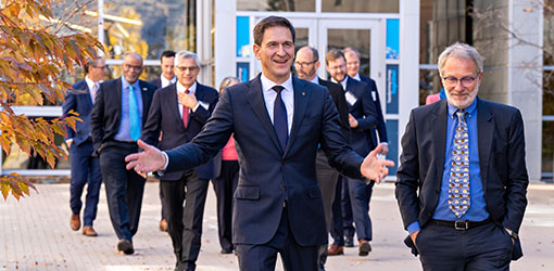 A group of people walking with one in front smiling